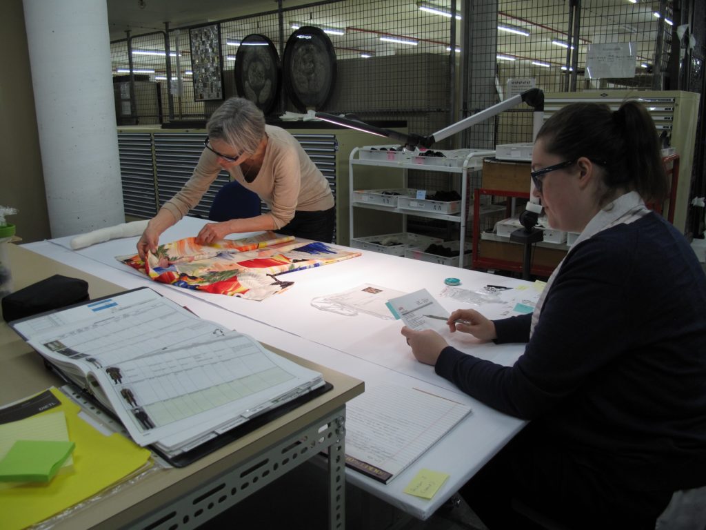 LACMA conservator and MAAS Assistant Conservator examine objects to record condition changes